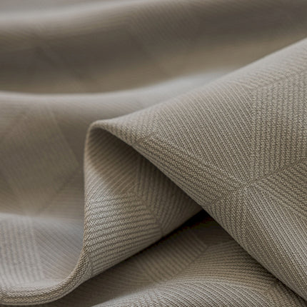 a close up of a beige fabric with a diamond pattern
