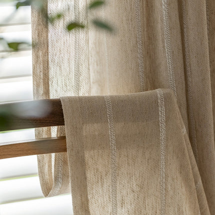 a close up of a window with a curtain