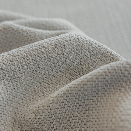 a close up of a bed with a white blanket