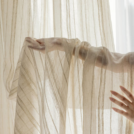 a woman's hand reaching out from behind a sheer curtain