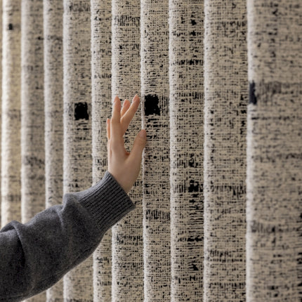 a person reaching out to touch a wall with their hand
