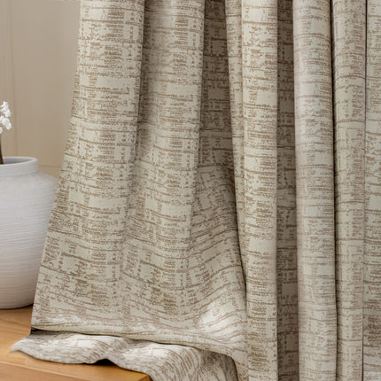 a white vase with a flower in it next to a curtain