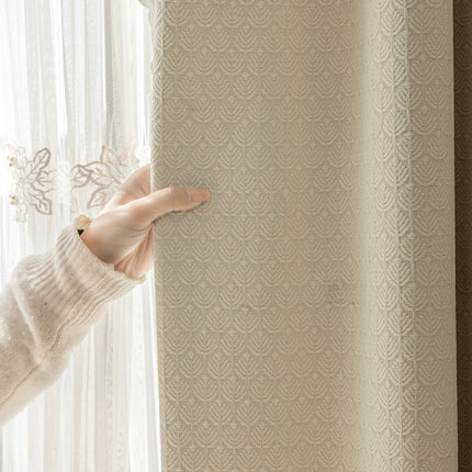 a person holding a curtain with their hand