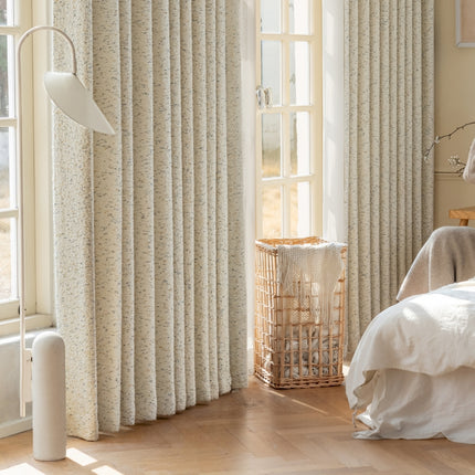 a bedroom with a bed and a window with curtains