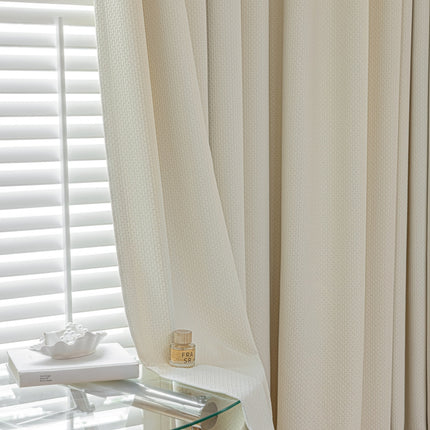 a bedroom with a glass table and white curtains