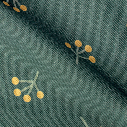 a close up of a green fabric with yellow dots