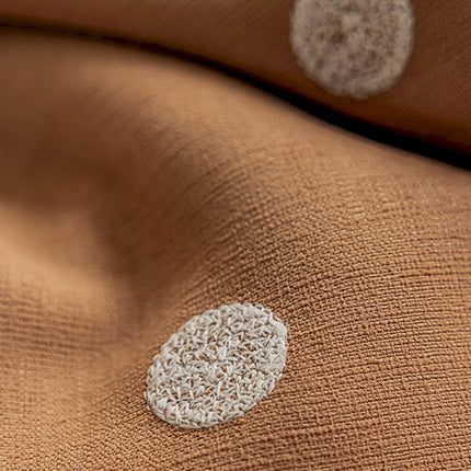 a close up of a blanket with a white circle on it