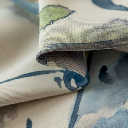 a close up of a blue and green flowered fabric