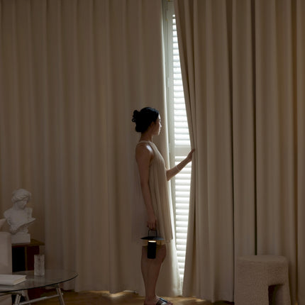 a woman standing in front of a window