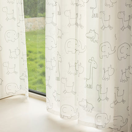 a window with a curtain that has drawings on it