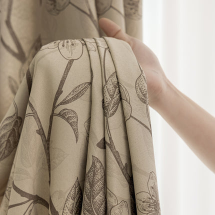 a person holding a curtain with a flower pattern