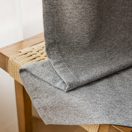 a close up of a chair with a blanket on it