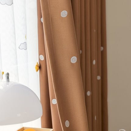 a white lamp sitting on top of a table next to a window