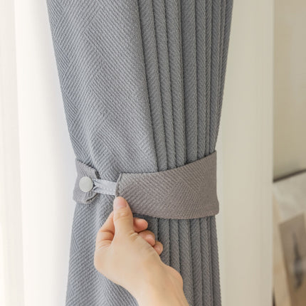 a person is pulling the curtain off of a window