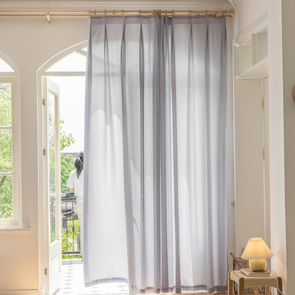 a living room with a large window and curtains