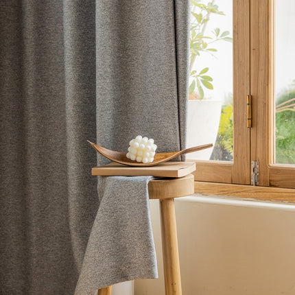 a wooden spoon sitting on top of a table next to a window