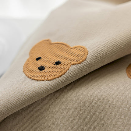 a close up of a pillow with a teddy bear on it