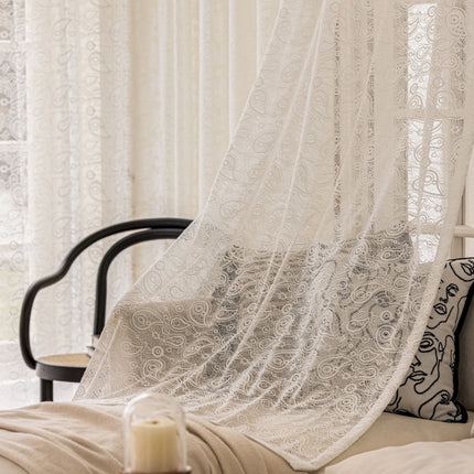 a bed with a white curtain over it
