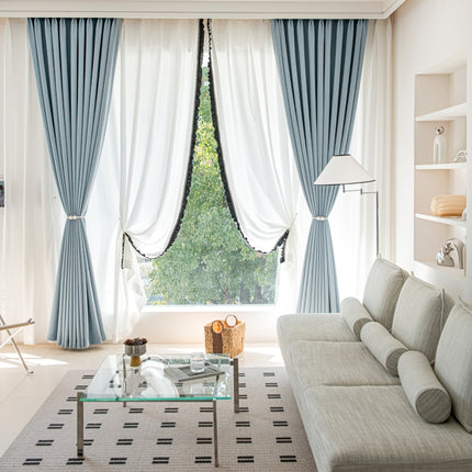 a living room filled with furniture and a large window