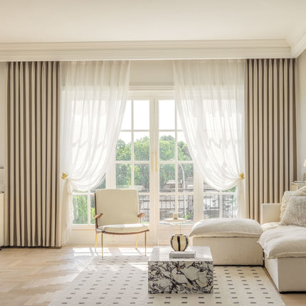 a living room filled with furniture and a large window