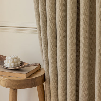 a wooden stool sitting next to a window with a curtain