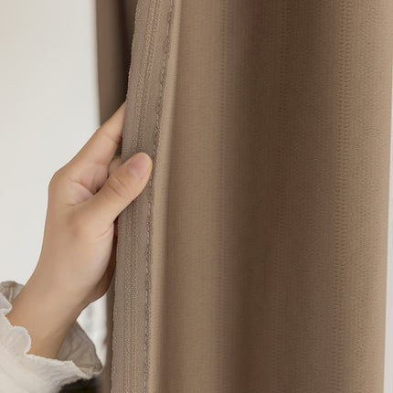 a person's hand is peeking through a curtain