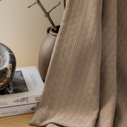 a book sitting on top of a table next to a vase