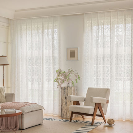 a living room filled with furniture and a large window