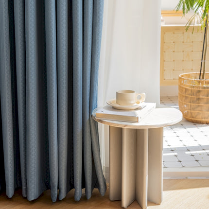 a table with a cup on top of it next to a window