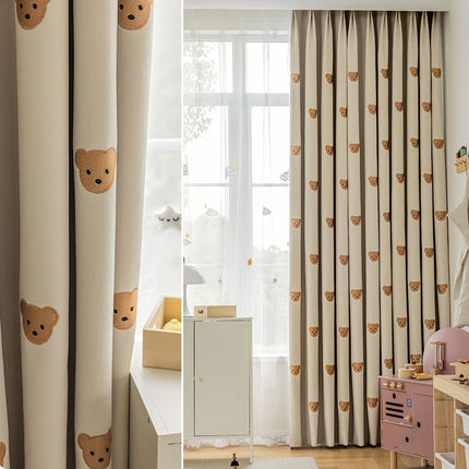 a child's bedroom with a teddy bear curtain