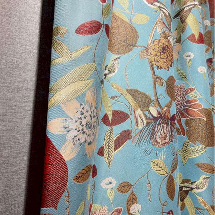 a close up of a curtain with flowers on it
