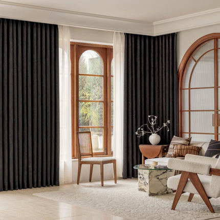a living room filled with furniture and a large window