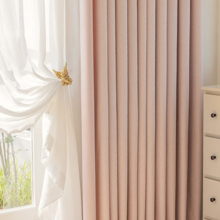 a window with a white curtain and a white dresser