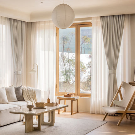 a living room filled with furniture and a large window