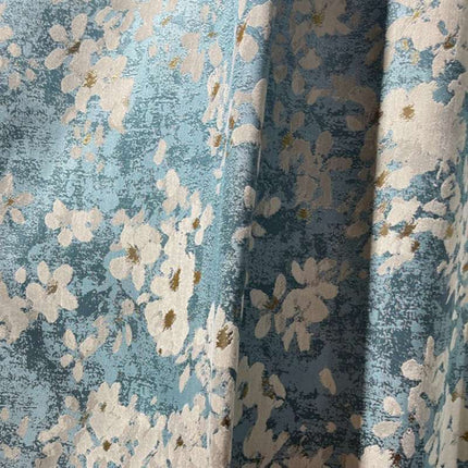 a close up of a blue and white flowered fabric