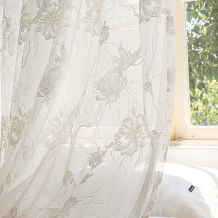 a window with a white curtain and a white pillow