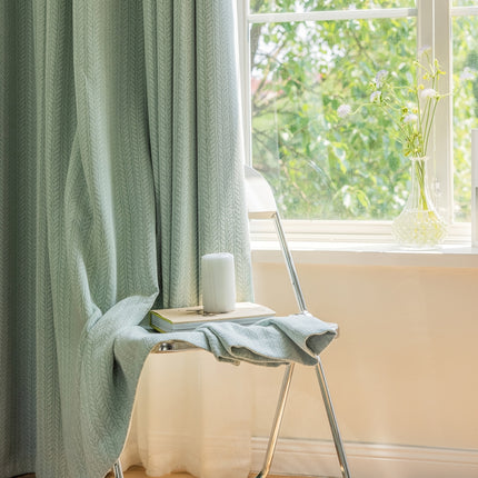 a chair with a towel on it next to a window