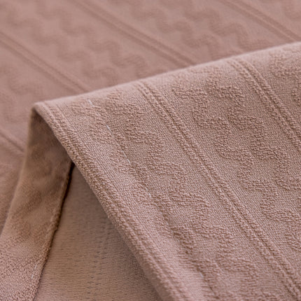 a close up of a blanket on a bed