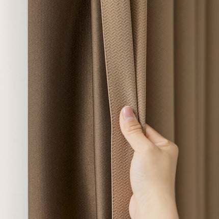a person's hand is pulling the curtain off of a window