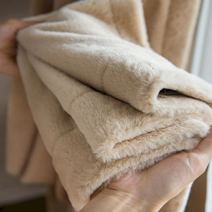 a person holding a blanket in their hands