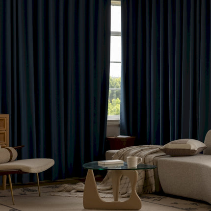 a living room with a couch, chair, coffee table and a window