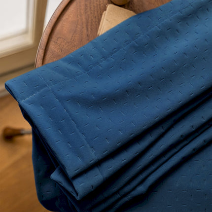 a close up of a blue cloth on a wooden chair