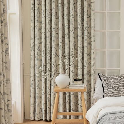 a bedroom with a bed and a window with curtains