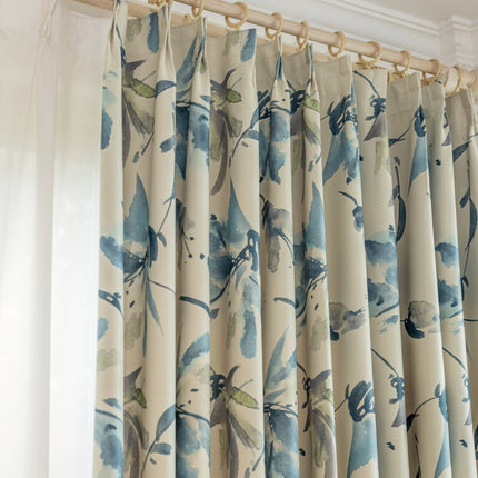 a close up of a curtain with blue flowers on it