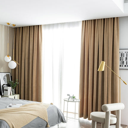 a bed room with a neatly made bed and a chair