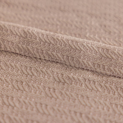 a close up of a blanket on a bed