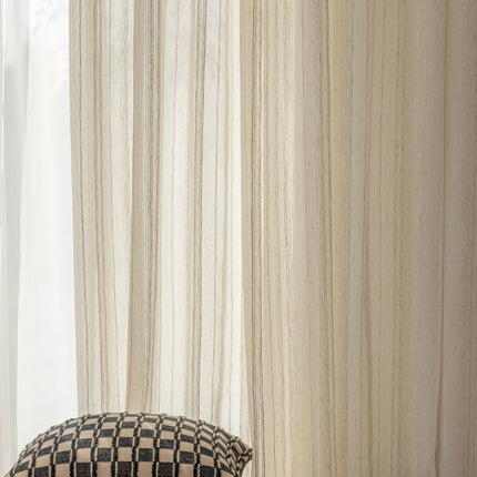 a black and white checkered pillow sitting next to a window
