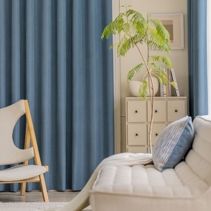 a living room with a white couch and a chair
