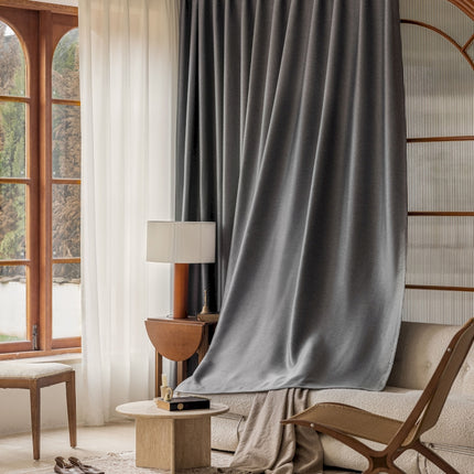 a living room with a chair and a window