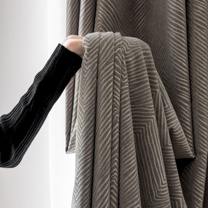 a person is holding a piece of cloth in front of a window